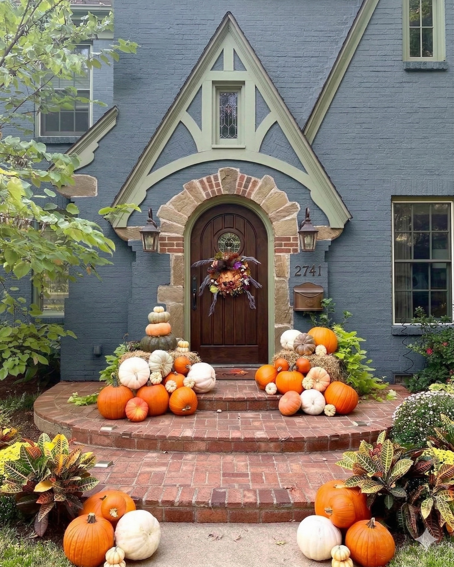 Pumpkin display on blue brick cottage steps
